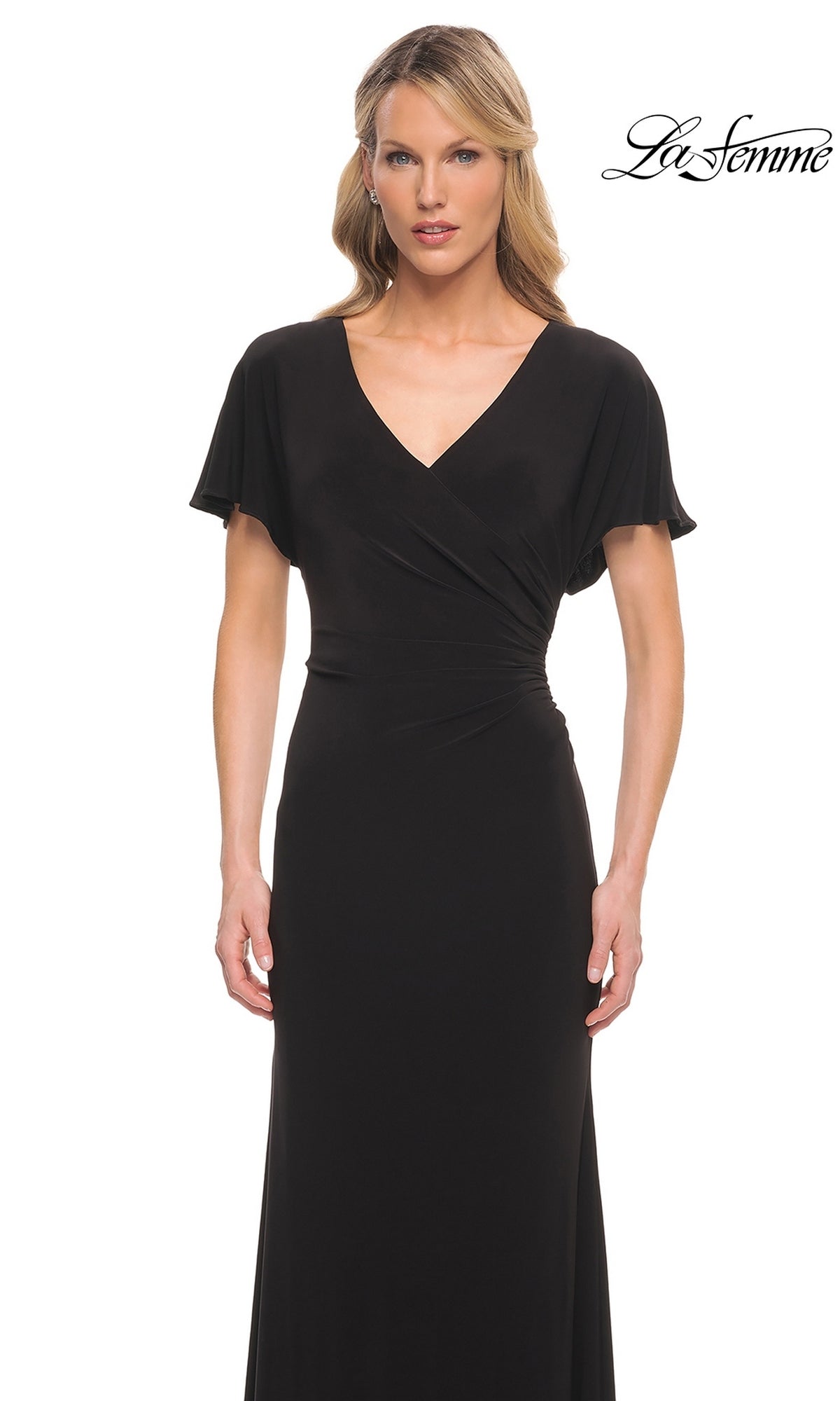 A woman wearing a Long Formal Dress: La Femme 29997, a floor-length jersey formal dress with a V-neckline, short flutter sleeves, and gathered waist detailing.